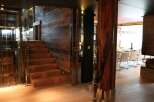 This stunning property boasts a unique blend of rustic and modern design, highlighted by a striking wooden staircase and glass elevator.