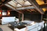 Luxury chalet with exposed wooden beams and skylights.