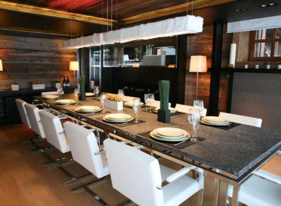 This stunning dining room boasts a sleek, modern design with a rustic touch.