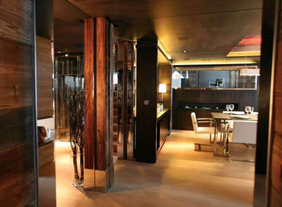 This luxurious apartment boasts a stunning open-plan living area with a sleek, modern dining space.