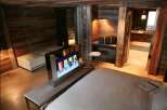 Luxury chalet bedroom with rustic wood walls and modern amenities.