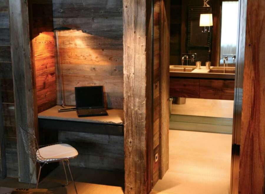 Rustic-chic bathroom with exposed wood beams and a sleek, modern vanity.