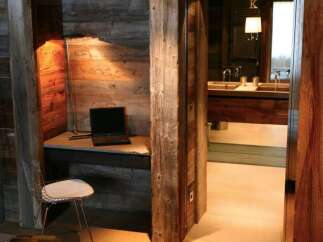 Rustic-chic bathroom with exposed wood beams and a sleek, modern vanity.