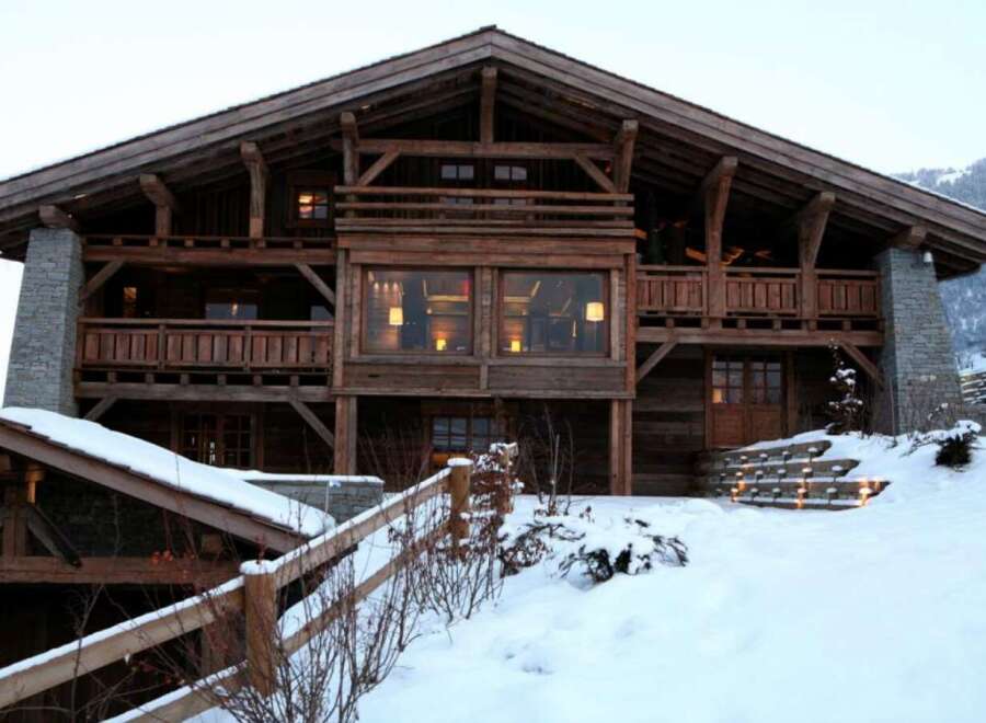 This stunning chalet boasts a rustic-chic design with exposed wooden beams and stone accents.