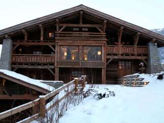 This stunning chalet boasts a rustic-chic design with exposed wooden beams and stone accents.