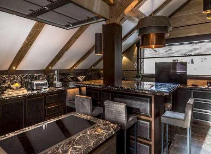 This luxurious kitchen boasts a stunning marble island with built-in seating, perfect for entertaining.