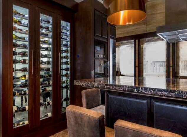 This luxurious home boasts a stunning built-in wine cellar, perfect for housing your extensive collection.