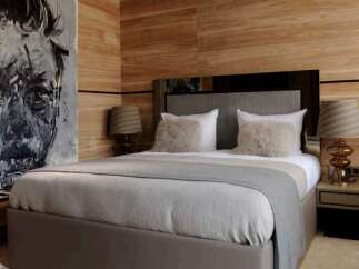 Luxurious bedroom with wood paneling and a plush bed.