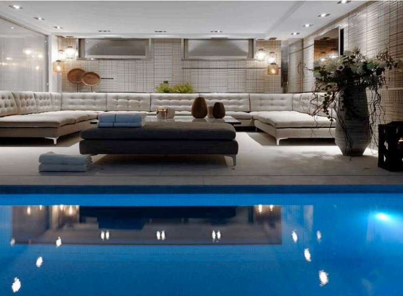 Indulge in luxury with this stunning property featuring an indoor pool and a spacious, elegantly designed living area.