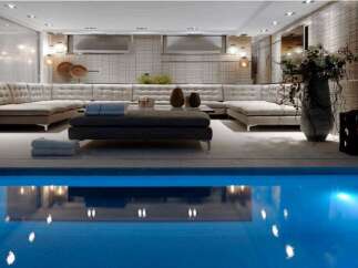Indulge in luxury with this stunning property featuring an indoor pool and a spacious, elegantly designed living area.