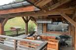 This stunning chalet boasts a spacious outdoor deck with breathtaking mountain views, perfect for enjoying the fresh air and stunning scenery.
