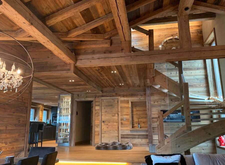 This stunning chalet boasts a magnificent exposed wood beam ceiling and walls, creating a warm and inviting atmosphere.