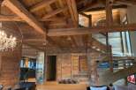 This stunning chalet boasts a magnificent exposed wood beam ceiling and walls, creating a warm and inviting atmosphere.