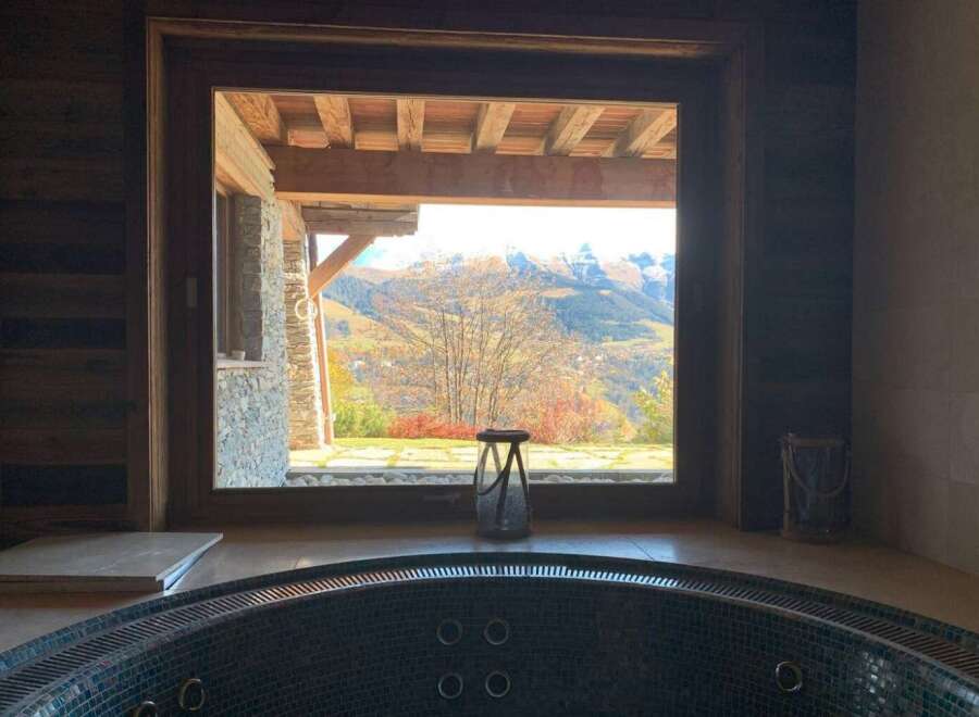 Indulge in ultimate relaxation in this luxurious hot tub, boasting breathtaking panoramic mountain views.