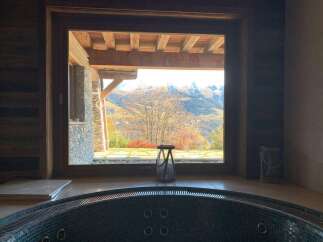 Indulge in ultimate relaxation in this luxurious hot tub, boasting breathtaking panoramic mountain views.
