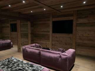 This luxurious home theater boasts stunning reclaimed wood walls and a coffered ceiling, creating a warm and inviting ambiance.