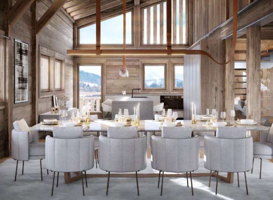 This stunning chalet boasts a spacious open-plan living area with floor-to-ceiling windows offering breathtaking mountain views.