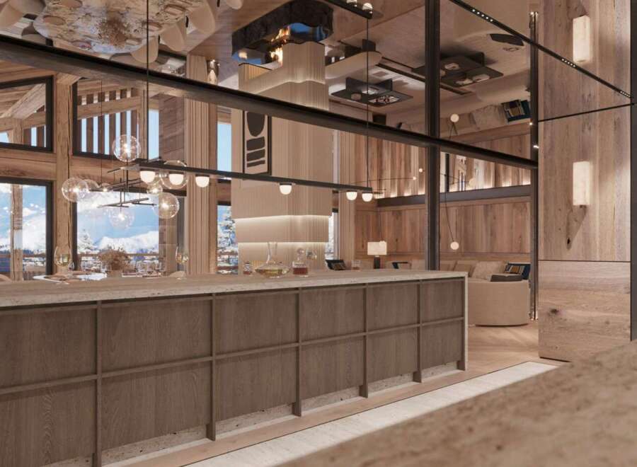 This luxurious chalet boasts a stunning open-plan living area with floor-to-ceiling windows offering breathtaking mountain views.