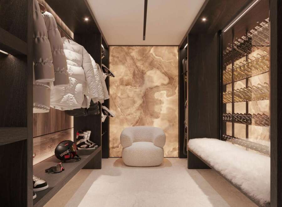 This luxurious ski room boasts custom cabinetry, ample storage for skis and snowboards, and a built-in wine cellar.