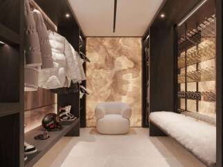 This luxurious ski room boasts custom cabinetry, ample storage for skis and snowboards, and a built-in wine cellar.