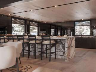 This stunning property boasts a breathtaking open-plan kitchen and bar area, perfect for entertaining guests.