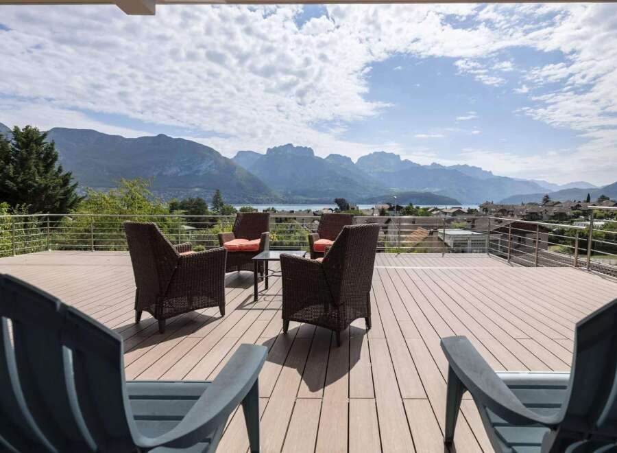 Luxury mountain view deck with composite decking and stainless steel railings.