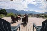 Luxury mountain view deck with composite decking and stainless steel railings.
