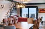 Stunning lake views from this modern apartment's dining area.