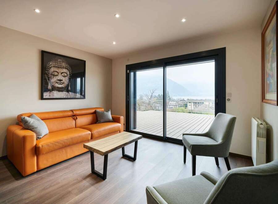 Relax and unwind in this stunning living space, featuring floor-to-ceiling windows showcasing breathtaking mountain views.