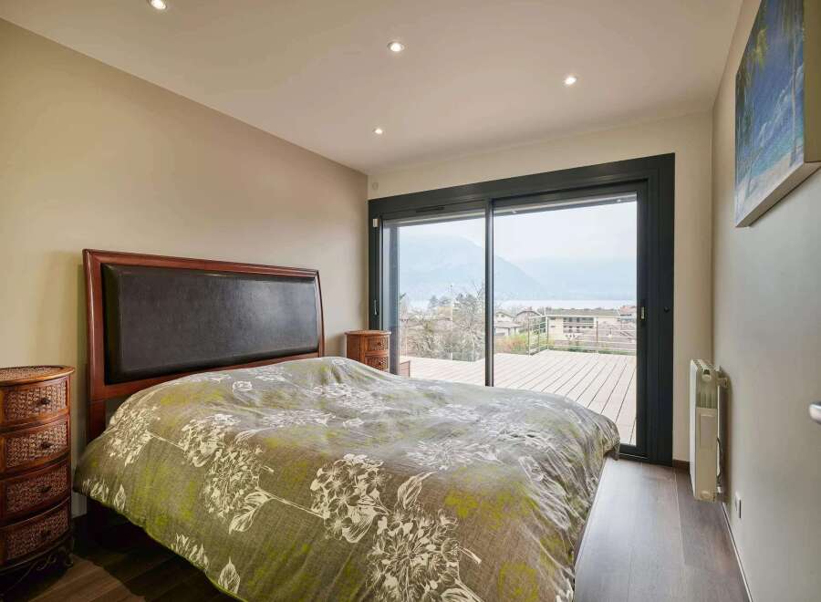 Wake up to breathtaking lake views from this luxurious bedroom.