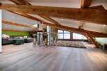 Stunning attic conversion boasts exposed wooden beams and expansive windows offering breathtaking views.
