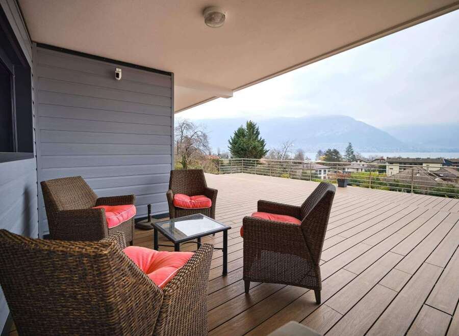 This stunning property boasts a spacious deck with breathtaking views of mountains and a lake.