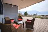 This stunning property boasts a spacious deck with breathtaking views of mountains and a lake.