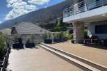 Luxury mountain villa with stunning views and spacious deck.
