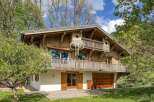 Discover the charm of this stunning wooden chalet nestled amidst lush greenery.