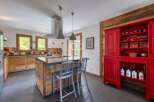 This stunning kitchen boasts a rustic charm with its wooden cabinetry and island.