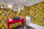 This vibrant bathroom features a unique tile design, creating a cheerful and inviting atmosphere.