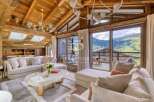 Experience luxury living in this stunning property, featuring a cozy living room with a fireplace and a breathtaking view.