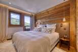 Experience luxury in this stunning bedroom with breathtaking mountain views.
