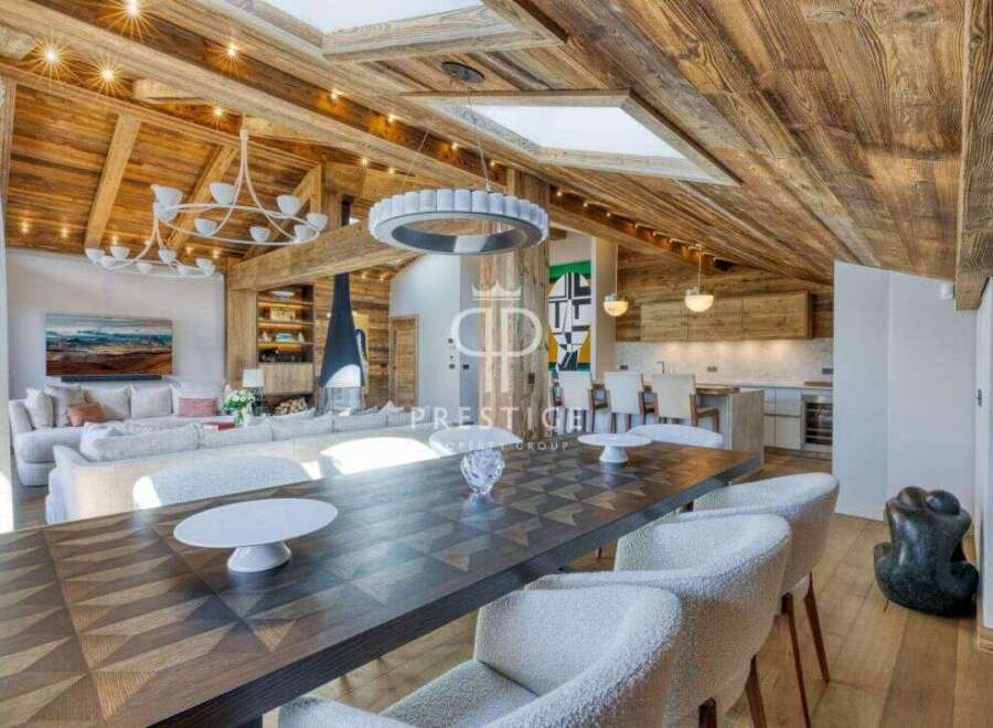 Experience luxury living in this stunning property, featuring a beautifully designed interior with exposed wooden beams and a cozy fireplace.
