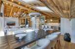 Experience luxury living in this stunning property, featuring a beautifully designed interior with exposed wooden beams and a cozy fireplace.