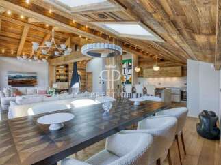 Experience luxury living in this stunning property, featuring a beautifully designed interior with exposed wooden beams and a cozy fireplace.