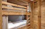 Discover the charm of this cozy bunk bed room, perfect for a family getaway.