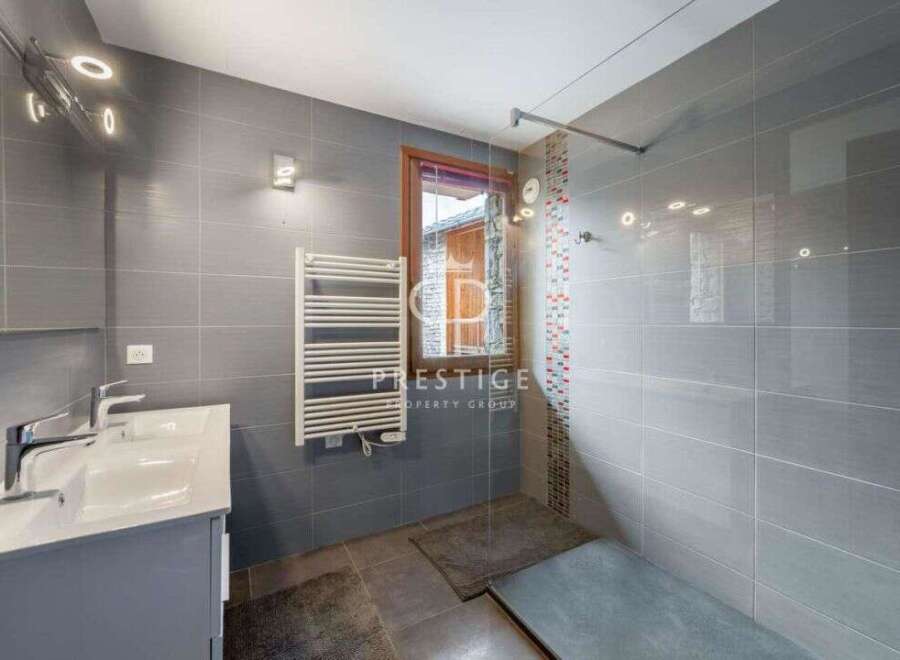 Discover a modern bathroom with sleek gray tiles and a stylish vanity.