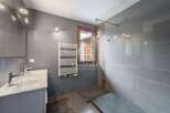 Discover a modern bathroom with sleek gray tiles and a stylish vanity.