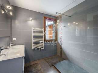 Discover a modern bathroom with sleek gray tiles and a stylish vanity.