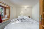 Cozy bedroom with a plush, inviting bed.