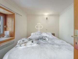 Cozy bedroom with a plush, inviting bed.