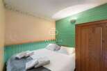Cozy bedroom featuring a comfortable bed with fresh white linens and plush pillows.