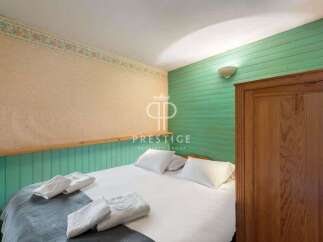 Cozy bedroom featuring a comfortable bed with fresh white linens and plush pillows.